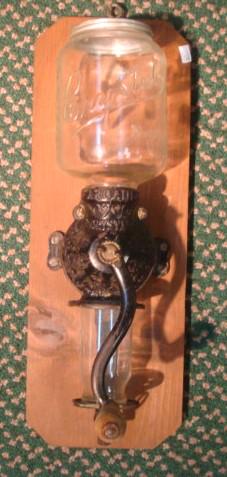 Antique Cast Iron Arcade Coffee Grinder, Glass Top:: Antique Cast Iron Arcade Coffee Grinder, Glass Top: Late 19th C. Wall Mount Coffee Grinder with Glass Catch Cup. Wooden Handle, Embossed Iron Black Metal Grinder. Metal Screw on Cover to Top. Mounted 