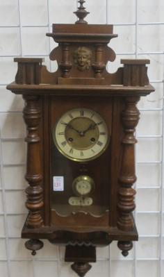 Junghaus Antique Regulator 8 Day Walnut Wall Clock:: Junghaus Antique Regulator 8 Day Walnut Wall Clock: Quality Clock c. 1890. Top Finial over Mask & Pillars. Roman Numerals on Clock Flanked by Turned Side Pillars. Lower Section with 3 Reverse Finials.