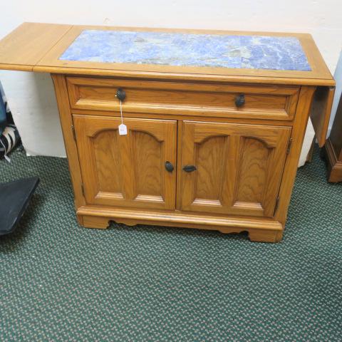 Thomasville Oak Drop Leaf Server with Tile Top:: Thomasville Oak Drop Leaf Server with Tile Top: Set in Blue Marble Tile Top over Single Drawer. Two Paneled Doors Below with Interior Shelf. Black Metal Leaf Design Pulls, Set on Bracket Feet. Slight