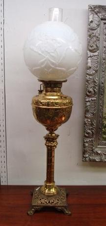 The MEDEOR Brass Banquet Lamp:: The MEDEOR Brass Banquet Lamp: Milk Glass Iris Shade on Column Stem on Pierced Square Footed Base. Repousee Front. 32"T. Made in USA. (200=300)