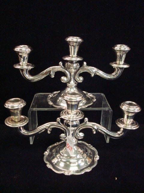 Pair of Sterling Silver 3 Light Candelabra: Pair of Sterling Silver 3 Light Candelabra: Each is 6 1/2"T with Shaped Flat Foot and 3 Candle Cups. One has had Repair on Arm. Marked on Bottom Sterling Perl 925. Over 24 Ozt. (100=200)