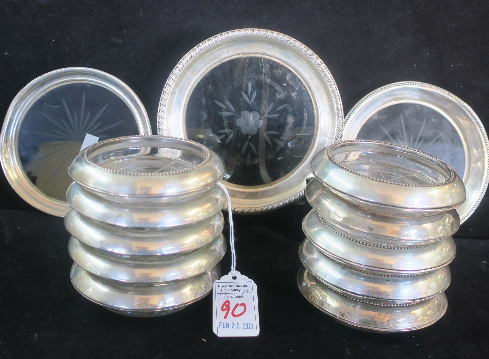 Thirteen Assorted Sterling Rim Glass Coasters:: Thirteen Assorted Sterling Rim Glass Coasters: Three Champagne Coasters with Cut Glass Centers are 5", 5 1/4" and 5 1/2"D. Ten Assorted Cup Coasters are 4"D. (100-200)