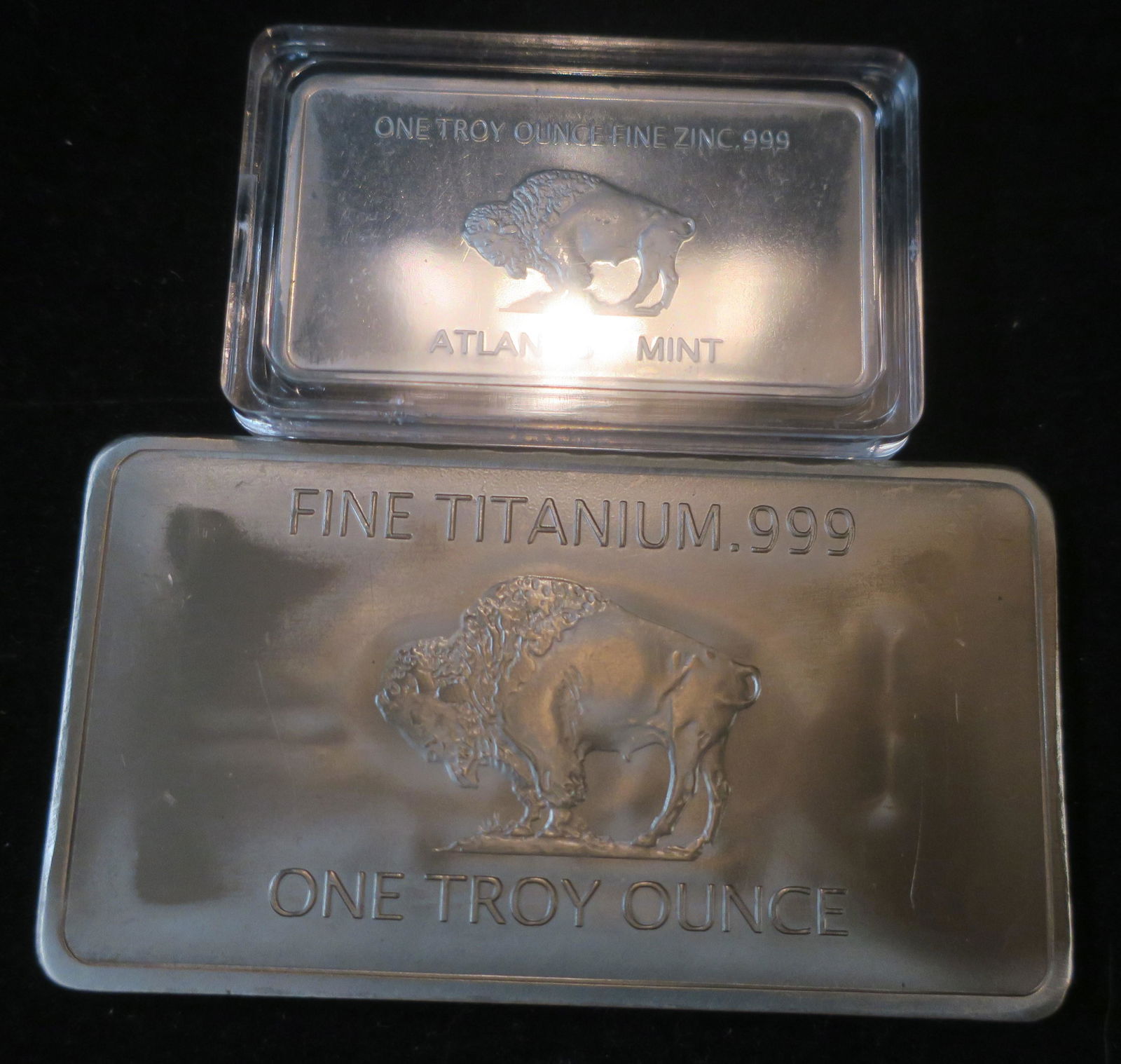 TITANIUM and ZINC INGOTS; 1 Troy Ounce Each:: TITANIUM and ZINC INGOTS; 1 Troy Ounce Each: 1 Troy Ounce of Zinc Decorated with American Buffalo from the ATLANTIS MINT. 1 Troy Ounce of Titanium Ingot Decorated with American Buffalo. (50-100)