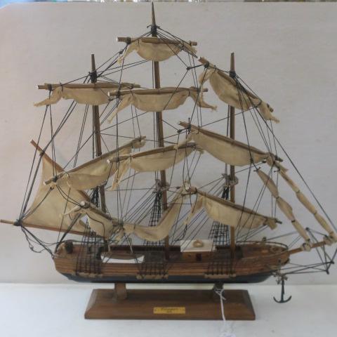 Model of an 1872 Clipper Ship:: Model of an 1872 Clipper Ship: Model of Three Masted Clipper Ship is 18 3/4"T and 22"L. Rigging with Anchors and Life Boat. Mounted on Wooden Base with Brass "Clipper 1872" Tag. (100-300)