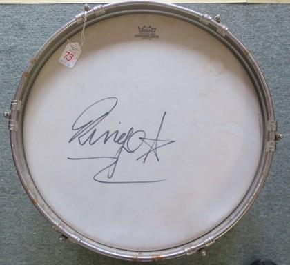 RINGO STARR AUTOGRAPHED REMO DRUM HEAD and Drum:: RINGO STARR AUTOGRAPHED REMO DRUM HEAD and Drum: 16 1/2" Tom Tom Drum with REMO WEATHER KING, Ambassador Batter Drum Head. With Photo of Ringo Starr and Certificate of Authenticity. Opening Bid $1000.