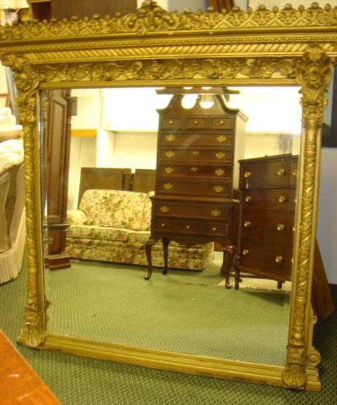 19th C. Large Gilt Frame French Antique Beveled Mi: 19th C. Large Gilt Frame French Antique Beveled Mirror: 64"T X 60"W. Incredible Deep Carved Plume, Flower, Foliage and Scroll Frame with Peaked Crest. Some Damage to Frame. Brought Back From Paris in