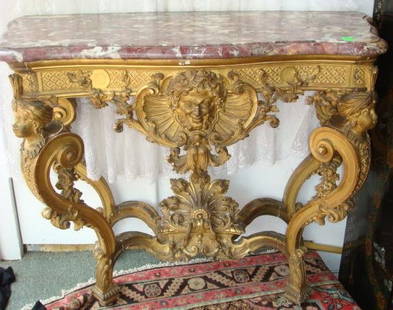 Exquisite Marble Top Rococo Revival Console Table: Exquisite Marble Top Rococo Revival Console Table: 1850's Figural Table with Italian Rose and Cream Marble Shaped Top. Serpentine Molded Top Having Conforming Frieze with Turbaned Heads Flanking Shell