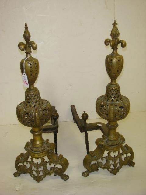Pair of Antique Brass Pierced Andirons: Pair of Antique Brass Pierced Andirons: Shaped Andirons with Fleur De Lis Tops and Paw Feet, Pierced Apron. 22"T.