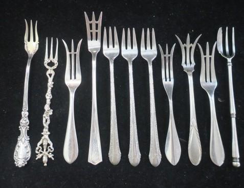 Ten Pieces of Sterling and 800 Silver Forks:: Ten Pieces of Sterling and 800 Silver Forks: Two Frank Whiting "Adams" Lemon Forks, Similar Fork Marked Sterling. Weidlich Lemon Fork. International "Deerfield" Olive Fork. Three Alvin "Chased Romanti