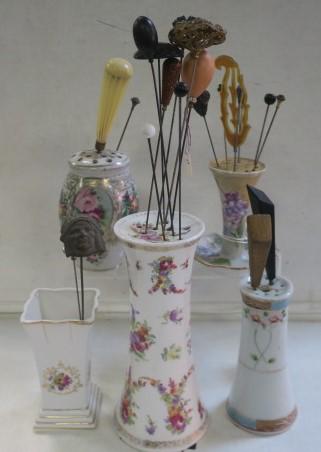 Five Ceramic Hat Pin Holders/Vases with Pins:: Five Ceramic Hat Pin Holders/Vases with Pins: Two Marked Japan are 4 1/4" and 5"T. 7 1/8"T with Illegible Mark and Cork Stopper. 4 1/2"T Barrel Shape with Stopper, 4"T Marked Limoges. 21 Assorted Hat