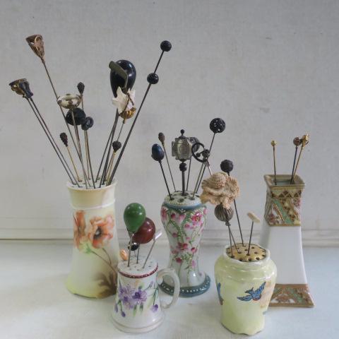Five Hand Painted Hat Pin Holders/Vase with Pins:: Five Hand Painted Hat Pin Holders/Vase with Pins: R.S. Germany 4 1/2"T Holder, C.S. & Co Bavarian Blue Bird with Cork Bottom is 3"T. Hand Painted Nippon 4 3/4"T Vase/Holder. Two Unmarked are 2 1/4" an