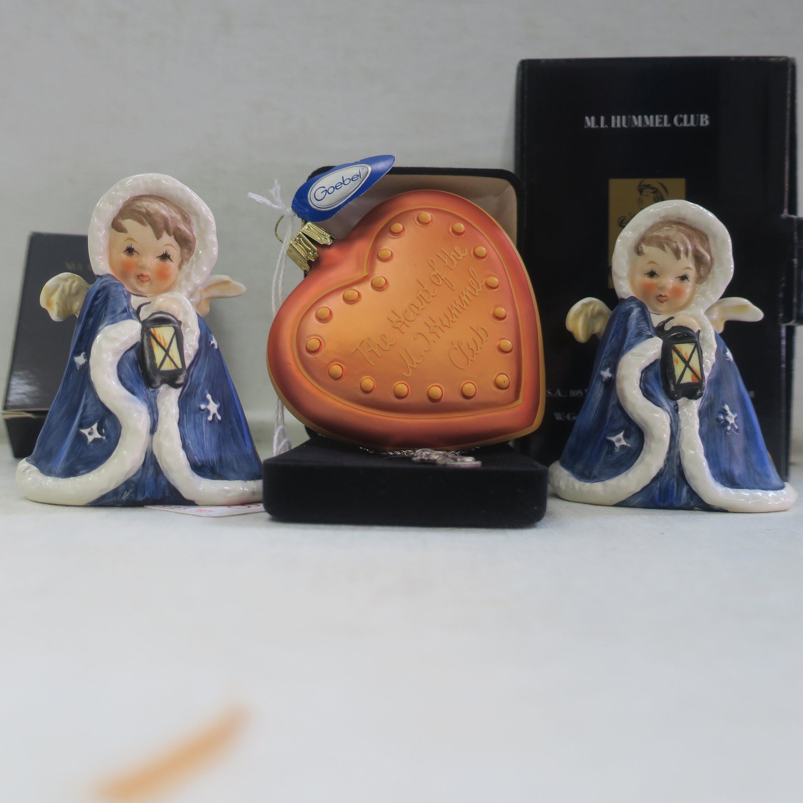 Two GOEBEL Angel Figurines, Necklace and Ornament:: Two GOEBEL Angel Figurines, Necklace and Ornament: Two Goebel "Angel with Lantern" Figurines Marked Rob 412, 1958, TMK-5. In Boxes. Hummel Collector Club Sterling Chain with Sterling "Merry Wanderer"