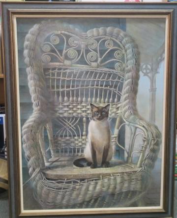 Artistic Rendition of Siamese Cat by ALLAN JONES:: Artistic Rendition of Siamese Cat by ALLAN JONES: Titled Visiting Royalty. Fraying Wicker Chair on Portico Taken Over by the Applehead Blue Eyed Siamese Princess. Measures 45" X 35" in Frame. Back of 