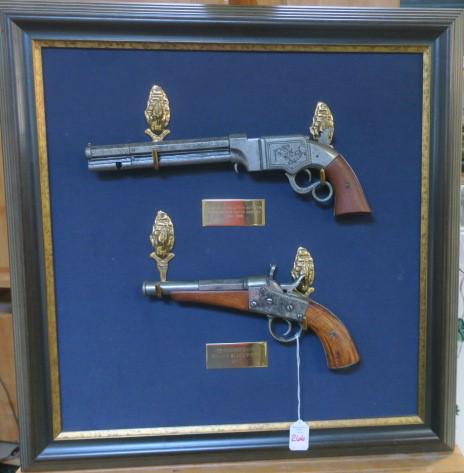 Pair of Replica Pistols on Framed Felt Mounting Board:: Pair of Replica Pistols on Framed Felt Mounting Board: Volcanic Lever Action Repeating Pistol by New Haven Arms Co. 1854-1860. Remington Navy Rolling Block Pistol, 1867. Framed on Felt to 26 1/2" Squa