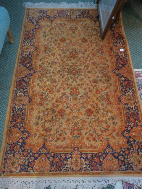 Indo-Persian Orange Ground Rug with Floral Designs:: 284. Indo-Persian Orange Ground Rug with Floral Designs: Irregular Blue Border Decorated with Temple Images. ($200-$400)