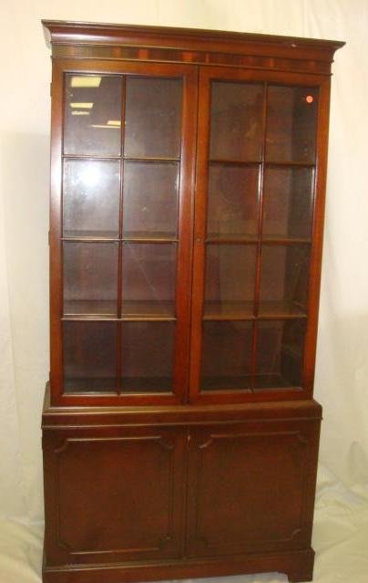 Mid 20th C. Mahogany China Cabinet:: Mid 20th C. Mahogany China Cabinet: Flat Molded Cornice over Double Glazed Doors. Three Interior Shelves. Lower Section has Double Door Blind Cabinet with Interior Shelf. Raised on Modified Bracket Fe