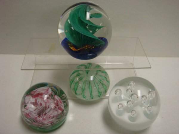 4 Glass Paperweights:: 4 Glass Paperweights: 3 14"T Green Swirled on Blue Bottom, 3"T White with Bubbles, 2 1/4"T Pink and White On Green Bottom, 1 1/2"T Green and White Ribbon.