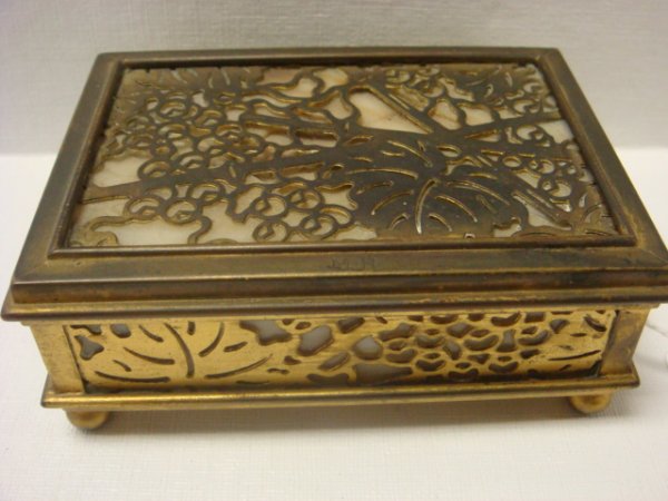TIFFANY STUDIOS Bronze and Slag Glass Box:: TIFFANY STUDIOS Bronze and Slag Glass Box: 1 5/8"T, 3" X 4 1/4". Grapevine Pattern Bronze Overlay on Caramel Slag Glass. Rests on Ball Feet. Hairline in Glass, Hinges Mended. Stamped Tiffany Studios, 
