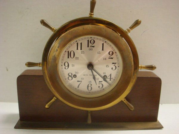 SETH THOMAS Helmsman Ships Bell Clock: SETH THOMAS Helmsman Ships Bell Clock: 8 Day Wind, Strikes According to Shipboard Watches. From General Time Services. Has Key. 8 1/2"T X 10 1/2"W. Metal Face and Spade Hands. (100-150)