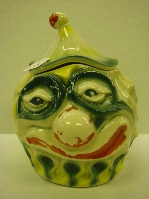 McCOY Sad Clown Cookie Jar: McCOY Sad Clown Cookie Jar: 9 1/2"T, Marked 255 McCoy USA. Made in 1970-1971. Cold Painted Red Mouth, Nose and Ball on Hat are Worn. Small Chip on Rim of Hat. (125-150)