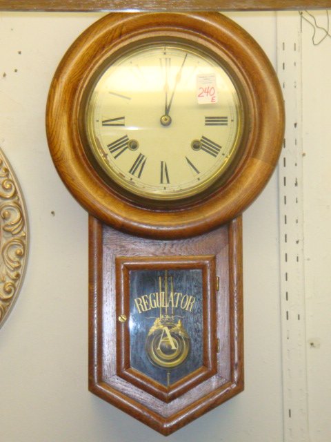 ANSONIA Oak Case Regulator A Clock Ca 1900:: ANSONIA Oak Case Regulator A Clock Ca 1900: Clock has Porcelain Tin Face with Roman Numerals, Pendulum with Grape Leaves, Key. Time and Strike. 22"L, 12"W. (60-100)