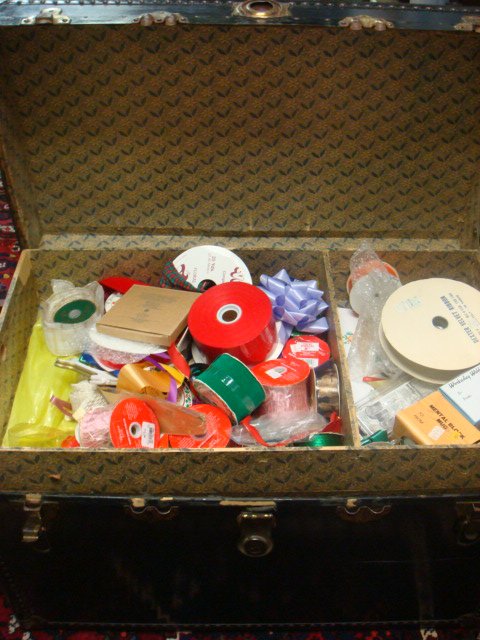 Black Trunk with Toys, Ribbon and Linens:: Black Trunk with Toys, Ribbon and Linens: Til Full of Ribbon. Hardy Boys, Fire Hat, Table Clothes, New Hankies, Drum, Puzzle, Santa Bank, 1972 More. (50-100)