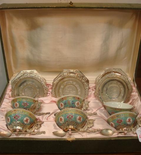 1930's Chinese Tea Cups, Plates, Spoons in Box: 1930's Chinese Tea Cups, Plates, Spoons in Box: 6 Ceramic Hand painted Tea Cups Set in Metal Dragon Handled Cup Holders. 6 Octagonal Embossed and Pierced Rim 5" Saucers and Five 5"L Spoons Marked Saig