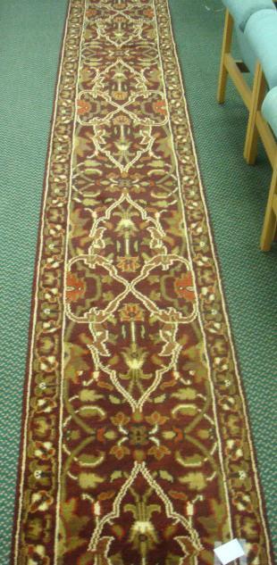 Hand-woven Wool 12' X 2'6" Indian Runner: 190: Hand-woven Wool 12' X 2'6" Indian Runner: 190 Single Border of Flower Rosettes. Intertwined Floral and Leaves on Burgundy Center Field. Thick Pile. (400-800)