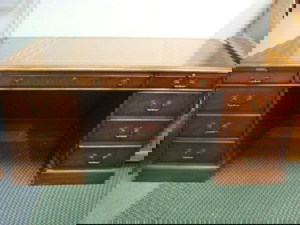 7 Drawer Executive Leather Top Desk: 7 Drawer Executive Leather Top Desk: 1940's Desk with Paneled Drawers. 1 Deep File Drawer. 3 Section Leather Top with gold Stenciling. 29 1/2"T X 34"D X 66"W. (200-400)