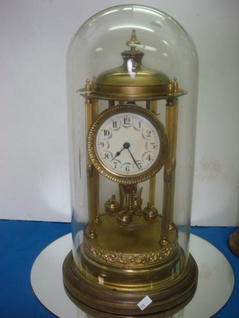 JAHRESUHRENFABRIK German Brass Anniversary Clock:: JAHRESUHRENFABRIK German Brass Anniversary Clock: 17"T with Glass Dome. Porcelain Face with Arabic Numerals and Handpainted Floral Swags Between Numbers. Chips on Edge of Glass Dome. Mark is 2 Elephan