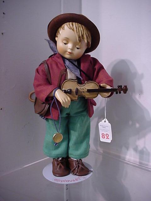 Hummel Little Fiddler Collector Doll: Hummel Little Fiddler Collector Doll: 1987 13"T. On Stand with Fiddle, Bow, Umbrella and Leather Bag. Ceramic Head and Limbs with Cloth Body. Call 757 722-9210 for Detailed Condition Reports.