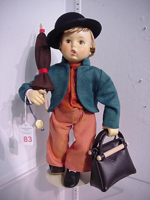 Hummel Merry Wanderer Collector Doll: Hummel Merry Wanderer Collector Doll: 13 1/2"T. 1990. On Stand with Umbrella and Vinyl Bag. Ceramic Head and Limbs with Cloth Body. Call 757 722-9210 for Detailed Condition Reports.