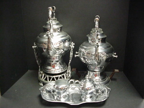 7 Piece United Chrome Coffee Service: 7 Piece United Chrome Coffee Service: 2 Chrome Electric Coffee Makers with Light Indicators and Black Bakelite Handles are 14"T. 8 3/4"T. Shared Pouring Stand and 7"D. Stand with Brown Bakelite Handle