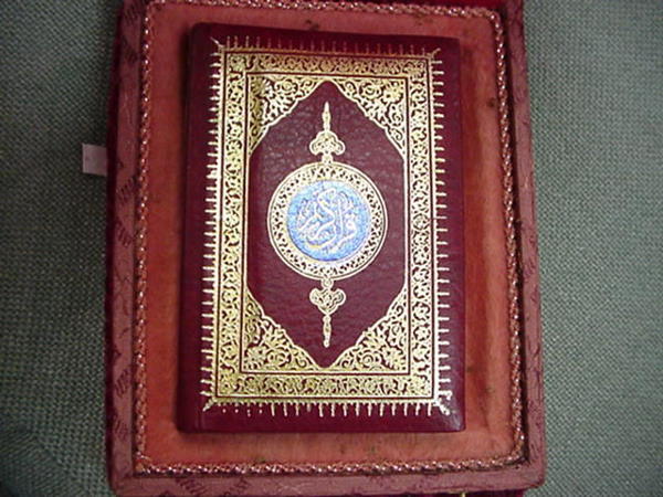 Hand Tooled Leather Bound Koran in Velvet Box: Hand Tooled Leather Bound Koran in Velvet Box: Felt and Satin Lined Velvet Covered Box with Brass Medallion Plate on Top, Closure, and Braid Under Rim. Book is 5 1/2" X 4". Islamic Quran in Arabic Cal