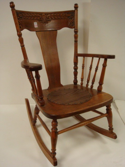 Oak Rocking Chair with Carved Acanthus Leaf Back:: Oak Rocking Chair with Carved Acanthus Leaf Back: Pressed Back 1940's Rocking Chair with Decorated Crest Rail. Spindle Sides, Replaced Seats. 25"W Seat, 36"T. (50-90)