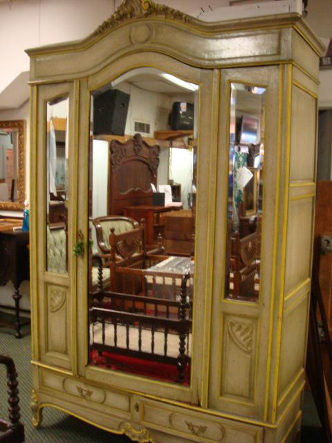 Bevel Mirrored Single Door Painted Wardrobe:: Bevel Mirrored Single Door Painted Wardrobe: Center Door and Left Panel Open. 2 Lower Key Lock Drawers. Carved Floral Spray Crest. Clothes Bar Inside. 4'9"W X 22"D X 8'1"T. Green and Yellow. (400-600)