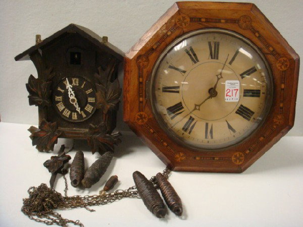 Marquetry Inlaid Wall Clock and Cuckoo Clocks:: Marquetry Inlaid Wall Clock and Cuckoo Clocks: Octagon Shaped Wooden Surround, Tin Face with Bell Ringer. Open Mechanism. Applied Carved Leaves, Marked Miken, Made in Japan, with Weights. (100-200)