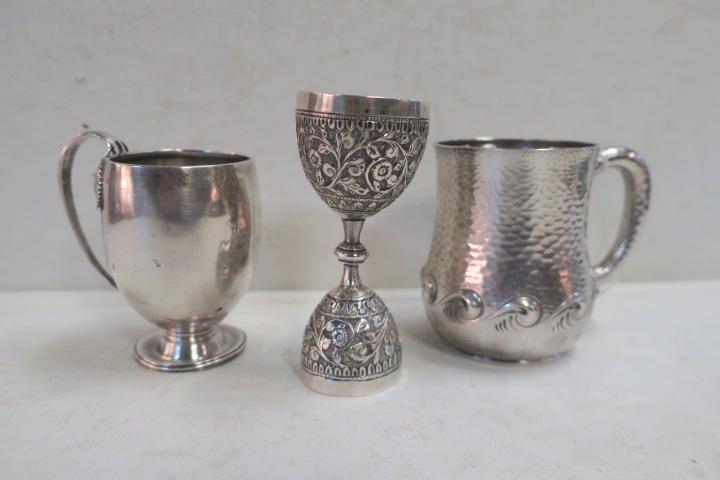 Two Antique Sterling Cups and Egg Cup:: Two Antique Sterling Cups and Egg Cup: Dominick & Haff Hand Hammered Handled Baby Cup Engraved on Bottom "Delos H. Smith May 10th 1884" Wave Pattern Around Bottom. 3 1/2"T. Handled Cup with Leaves Eng