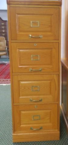 Solid Oak Four Drawer Locking File Cabinet:: Solid Oak Four Drawer Locking File Cabinet: With Keys, Gilt Hardware and Label Holders. Excellent Condition. 54" x 18 1/2" x 29". (200-400)