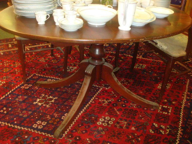 Duncan Phyfe Mahogany Single Pedestal Oval Table: Duncan Phyfe Mahogany Single Pedestal Oval Table: Turned Pedestal with 4 Brass Capped Splay Legs. 29"T, 41 1/2" X 54". (100-200)