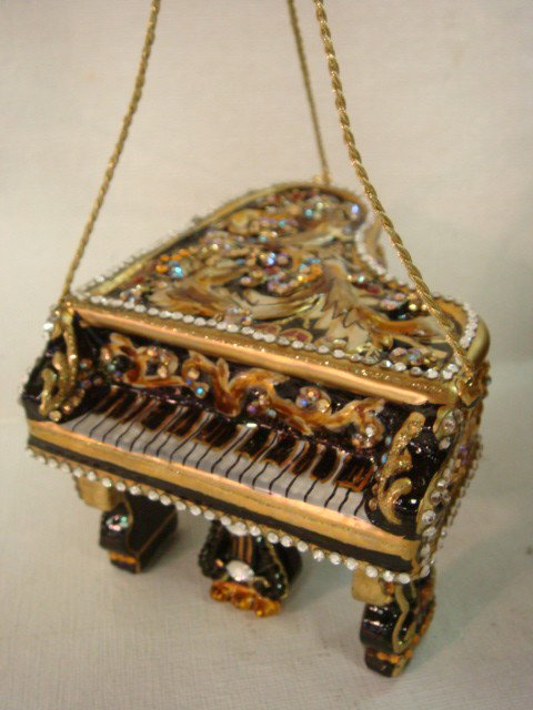 Signed JAY STRONGWATER Grand Piano Music Box:: Signed JAY STRONGWATER Grand Piano Music Box: Signed 2008. Hand Enameled in Black with Raised Acanthus Leaf on Top. Edged in Handset Swarovski Crystals.2 1/2"T with 4" X 3" Top. In Box. (300-500)