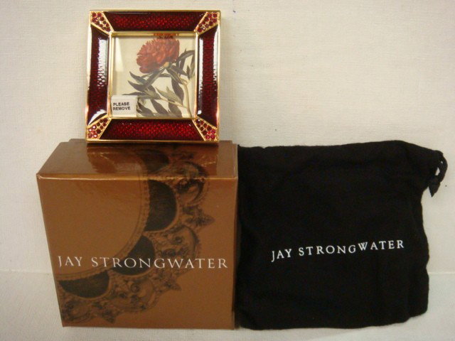 Signed JAY STRONGWATER Enamel & Crystal Picture Fr: Signed JAY STRONGWATER Enamel & Crystal Picture Frame In Cloth Pouch and Original Box. 2 3/4" Square with 1 3/4" Opening. Red Enamel with Swarovski Crystal Corners. Marked on Reverse. (60-100)