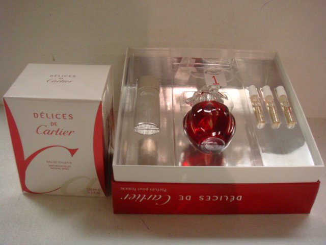 DELICES CARTIER Spray and Perfume Set:: DELICES CARTIER Spray and Perfume Set: 3.3 oz French Eau De Toilette Unopened. Atomizer with 3 Refills and Ruby Glass Bottle with Clear Petal Cap. New in Box. (60-100)