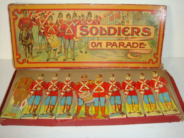 SOLDIERS ON PARADE, MILTON BRADLEY CO, CA 1905:: SOLDIERS ON PARADE, MILTON BRADLEY CO, CA 1905: 10 6" Tall Soldiers, One with Drum, One with Bugle, 7 with Rifles and one in Undress Uniform with out a Head. Box is Damaged but Good for Age. (150-300)