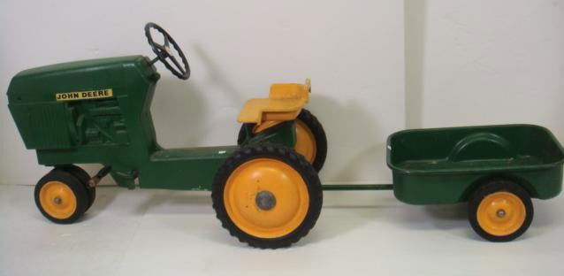 Child's John Deere Tractor & Trailer, CA 1950: Child's John Deere Tractor & Trailer, CA 1950: Child's Pedal Tractor with Steering Wheel. Very Good Condition. Tractor is 24" x 35" x 18" and Trailer is 9" x 29" x 16". (300-600)