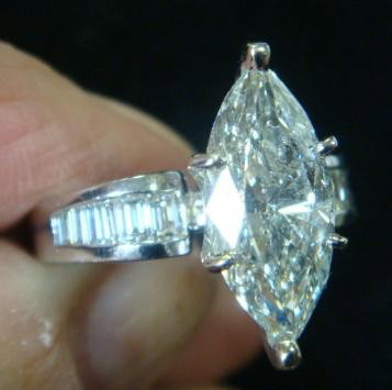 2.87 Ct Diamond Marquis in Platinum Ring:: 2.87CT Marquise Solitaire Diamond Platinum Ring: 6 Prong Set Center Stone Flanked by 5 Baguettes on Each Side. Size 7 3/4. (11000-15000)