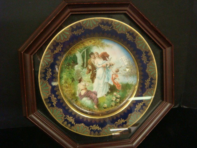 ROYAL VIENNA Framed Porcelain Plate:: ROYAL VIENNA Framed Porcelain Plate: Allegorical Scene of Courting Couple and Cupid, Sit in Octagonal Shadow Box Frame. Marked with Green Crown Royal Vienna. 9 1/2"W. 13" Wide Overall. (200-400)