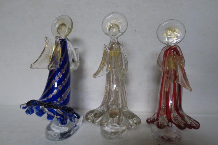 Three Murano Glass Angel Candle Holders:: Three Murano Glass Angel Candle Holders: One Clear, One Red Striped and One Blue Striped, All with Aventurine Stripes and Approximately 9"T. Winged Angels Hold Cup for Candle. (150-300)
