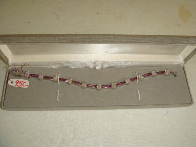 18KT CHARRIOL Pink Sapphire and Diamond Bracelet: 18KT CHARRIOL Pink Sapphire and Diamond Bracelet: 7 1/2"L with Blue Sapphire Clasp, 40 Pink Sapphires, 4.4CTS - 99 Round Diamonds, .5CTS. (2500-4000)