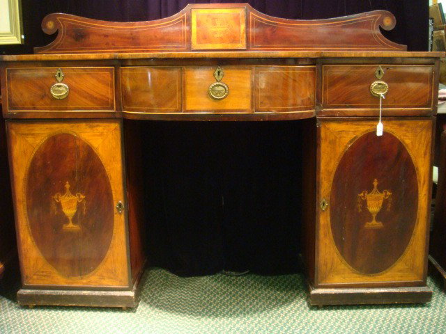 Early 19th C. English Inlaid Hepplewhite Sideboard: Early 19th C. English Inlaid Hepplewhite Sideboard: Back Splash with Urn Inlay on Banded Top over Swell Front Center. Flanking Center are Side Drawers Topping Fine Marquetry Inlaid Lower Cabinets. Pli